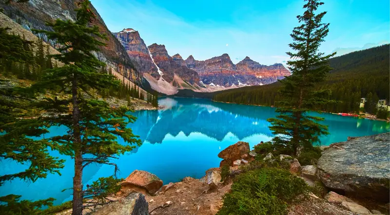 Turquoise Moraine Lake framed by pines and the Valley of the Ten Peaks in summer